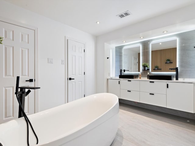 bathroom featuring a bathing tub and vanity