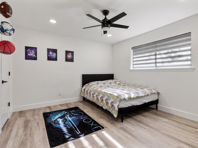 bedroom with ceiling fan and wood-type flooring