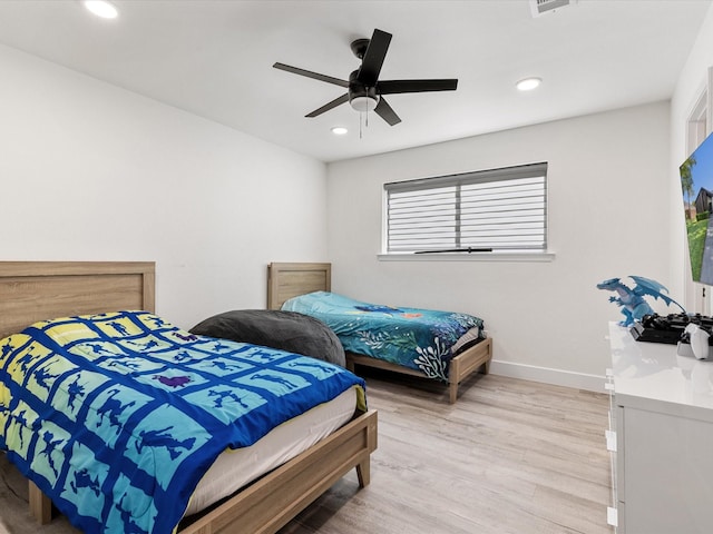 bedroom with ceiling fan and light hardwood / wood-style floors