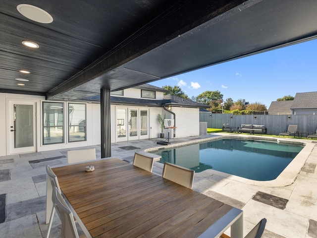 view of pool featuring a patio and french doors