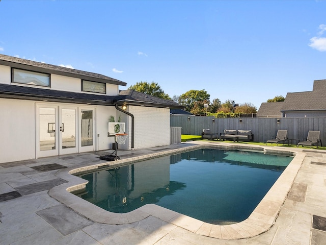 view of pool featuring an outdoor hangout area, a patio, and french doors