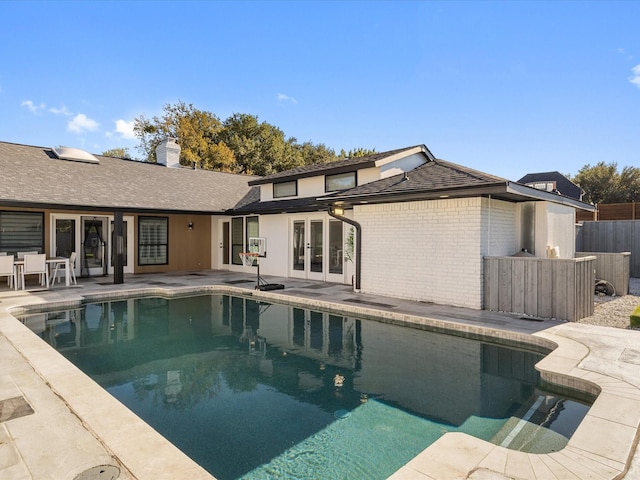 view of pool featuring french doors and a patio