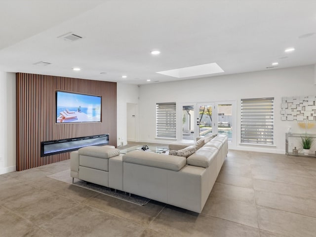 living room featuring a skylight