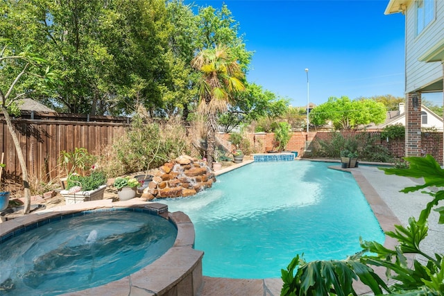 view of pool featuring an in ground hot tub