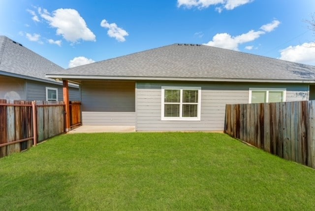 rear view of house with a yard