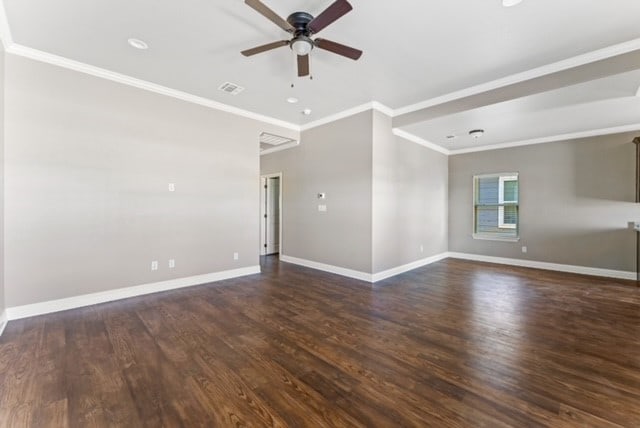 spare room featuring ornamental molding, ceiling fan, and dark wood-type flooring