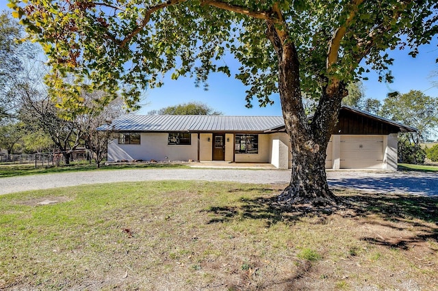 single story home featuring a garage, a porch, and a front yard