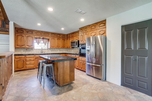 kitchen with wood ceiling, vaulted ceiling with beams, hanging light fixtures, ceiling fan with notable chandelier, and a center island