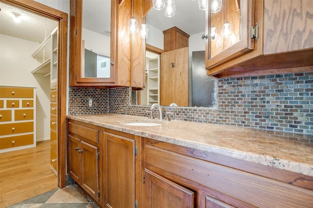 bathroom with vanity and tasteful backsplash