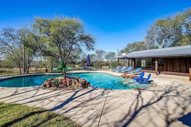 view of swimming pool with a patio area