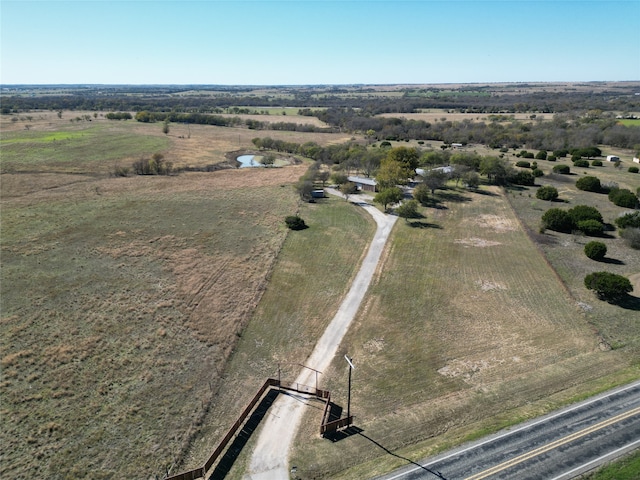 birds eye view of property with a rural view