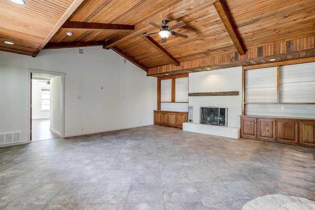 unfurnished living room with ceiling fan, wooden ceiling, a fireplace, and vaulted ceiling with beams