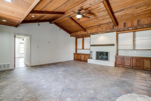 unfurnished living room with a brick fireplace, wood ceiling, and beam ceiling