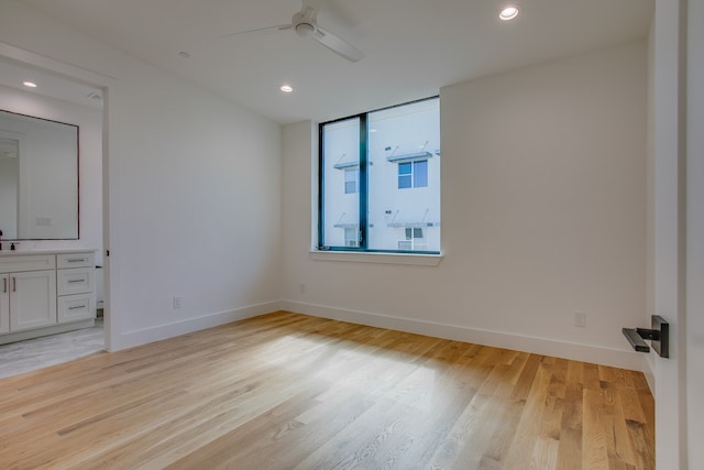 empty room featuring ceiling fan and light hardwood / wood-style flooring