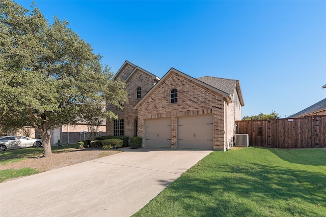 view of front of home with a garage, a front lawn, and cooling unit