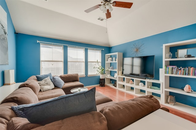 living room with ceiling fan, light hardwood / wood-style floors, and vaulted ceiling