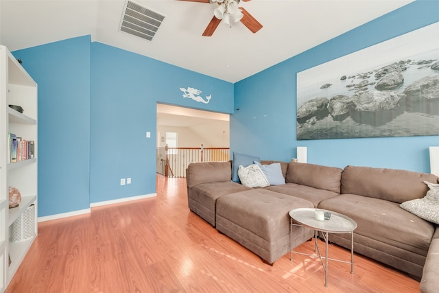 living room with ceiling fan, hardwood / wood-style floors, and lofted ceiling