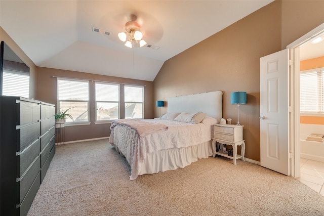 bedroom with carpet floors, ensuite bath, ceiling fan, and lofted ceiling