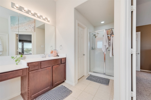 bathroom featuring tile patterned flooring, vanity, and a shower with door