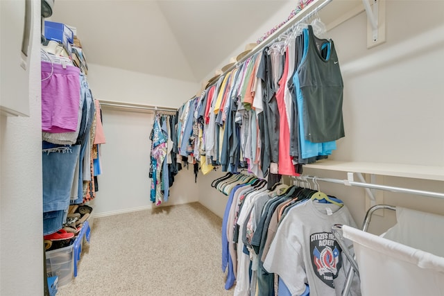 walk in closet featuring carpet and lofted ceiling