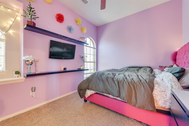 carpeted bedroom featuring vaulted ceiling and ceiling fan