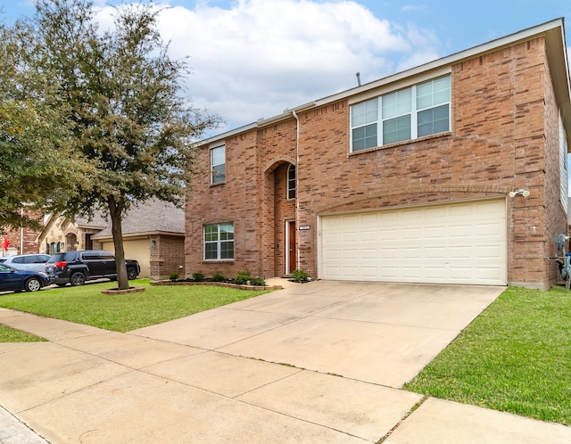 view of front of house featuring a front yard and a garage