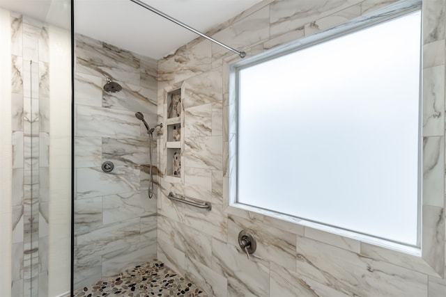 bathroom with a tile shower