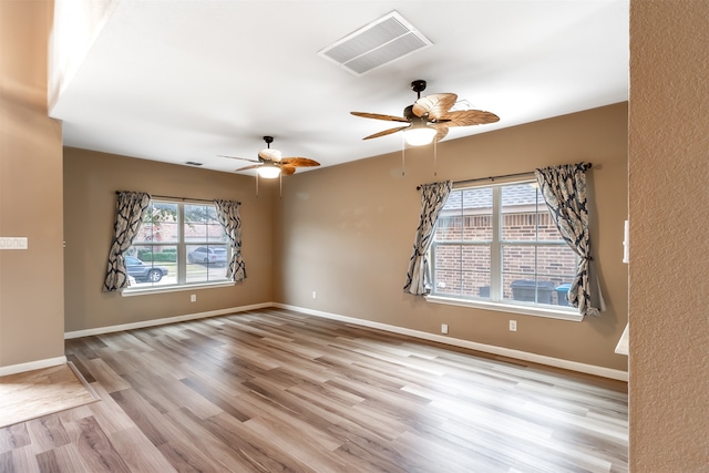 spare room featuring ceiling fan and light hardwood / wood-style flooring