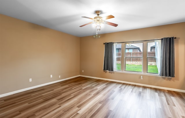 unfurnished room featuring light hardwood / wood-style floors and ceiling fan