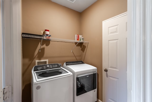 washroom featuring washer and clothes dryer