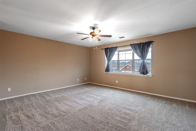 empty room with carpet flooring and ceiling fan