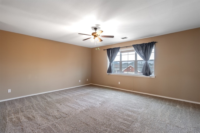 unfurnished room with carpet floors and ceiling fan