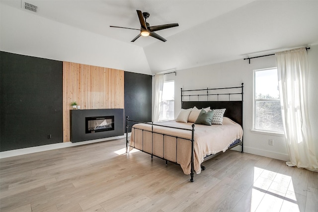 bedroom featuring light hardwood / wood-style flooring, ceiling fan, and lofted ceiling