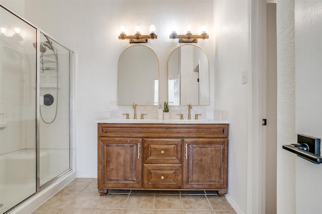 bathroom with tile patterned flooring, vanity, and a shower with door