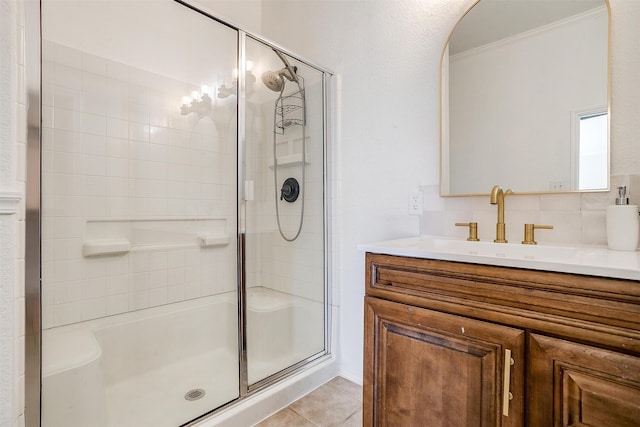 bathroom featuring decorative backsplash, vanity, tile patterned flooring, and a shower with shower door