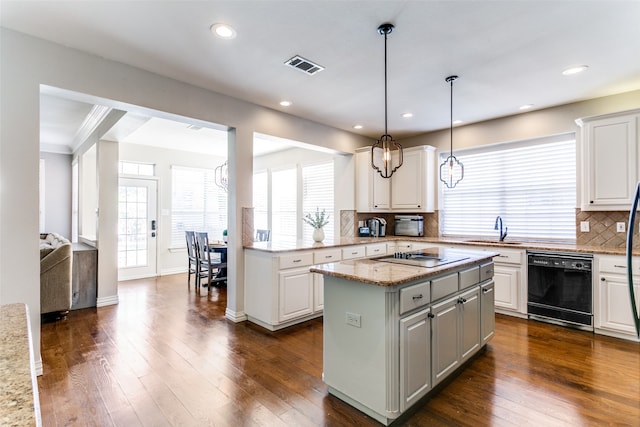 kitchen featuring dishwasher, white cabinetry, light stone countertops, and hanging light fixtures