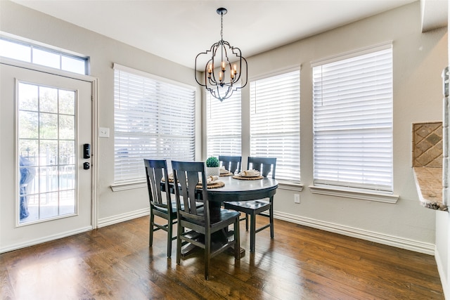 dining space featuring dark hardwood / wood-style floors and a notable chandelier