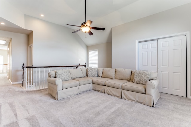 carpeted living room featuring ceiling fan and high vaulted ceiling