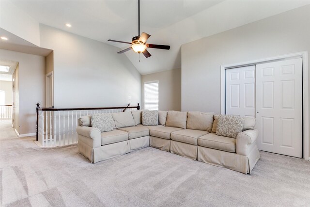 carpeted living room featuring high vaulted ceiling and ceiling fan