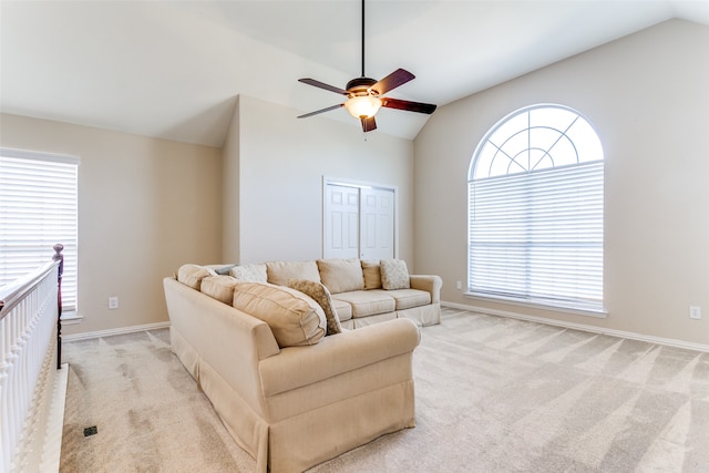 carpeted living room featuring plenty of natural light, ceiling fan, and lofted ceiling