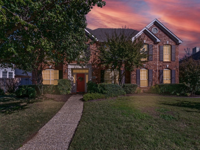 view of front of property with a lawn