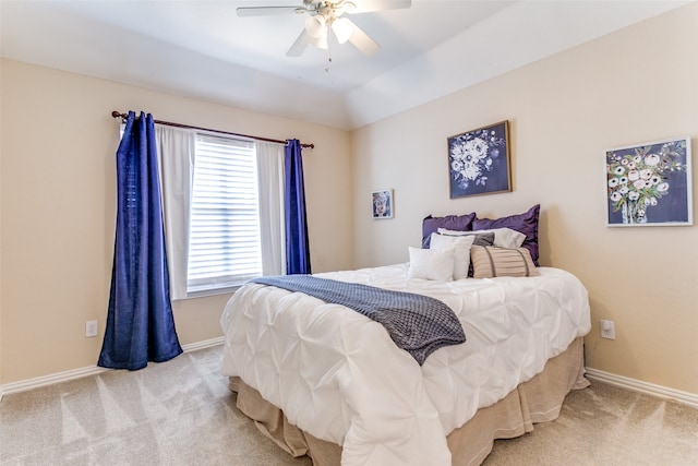 carpeted bedroom with ceiling fan and lofted ceiling