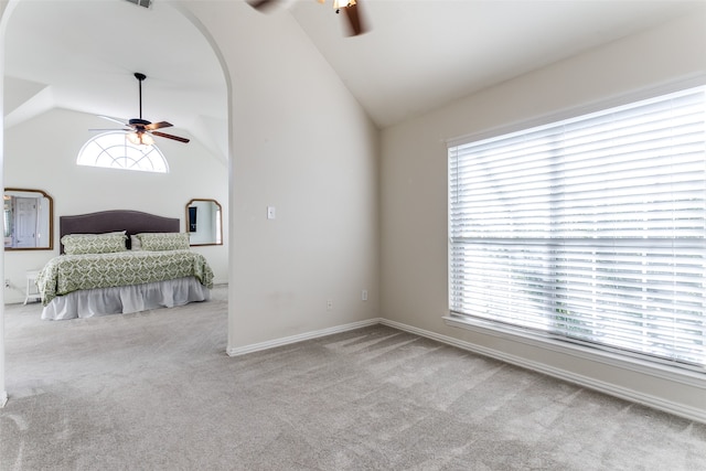 bedroom featuring ceiling fan, light colored carpet, and high vaulted ceiling