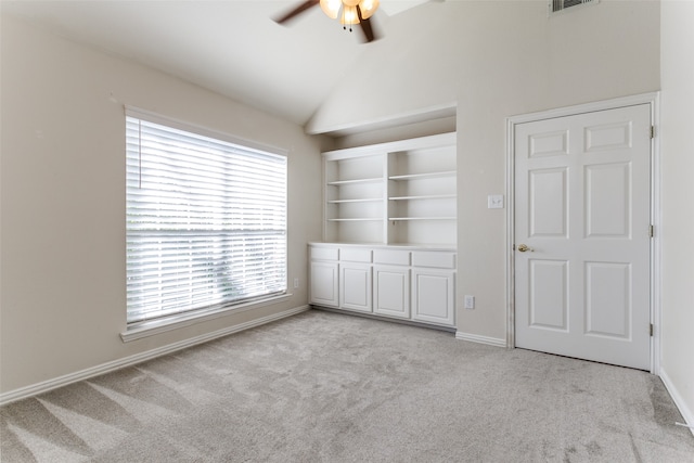 unfurnished bedroom featuring ceiling fan, light carpet, and vaulted ceiling