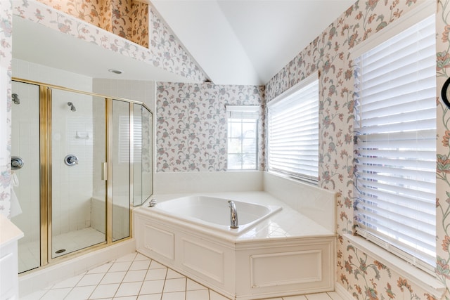 bathroom with tile patterned floors, independent shower and bath, and vaulted ceiling