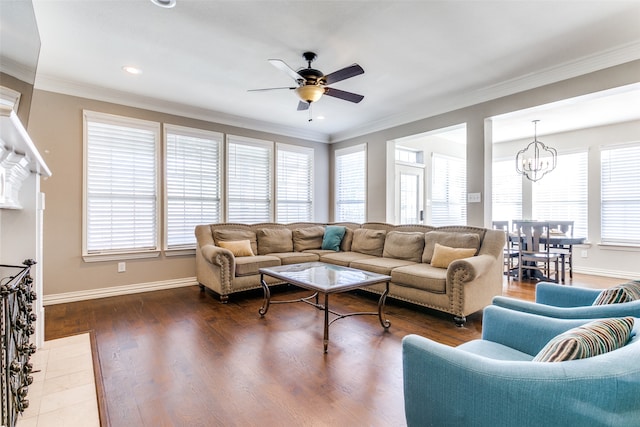 living room with ceiling fan with notable chandelier, dark hardwood / wood-style flooring, and ornamental molding