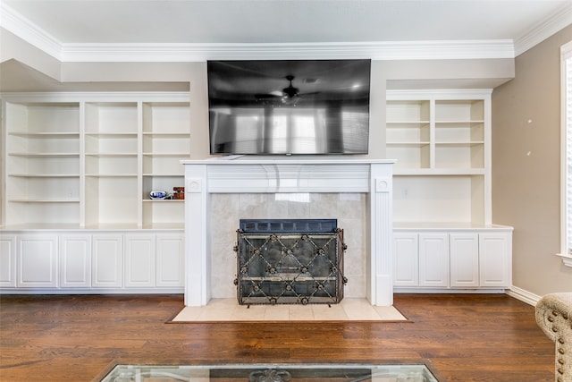 unfurnished living room with crown molding, dark wood-type flooring, and a tiled fireplace