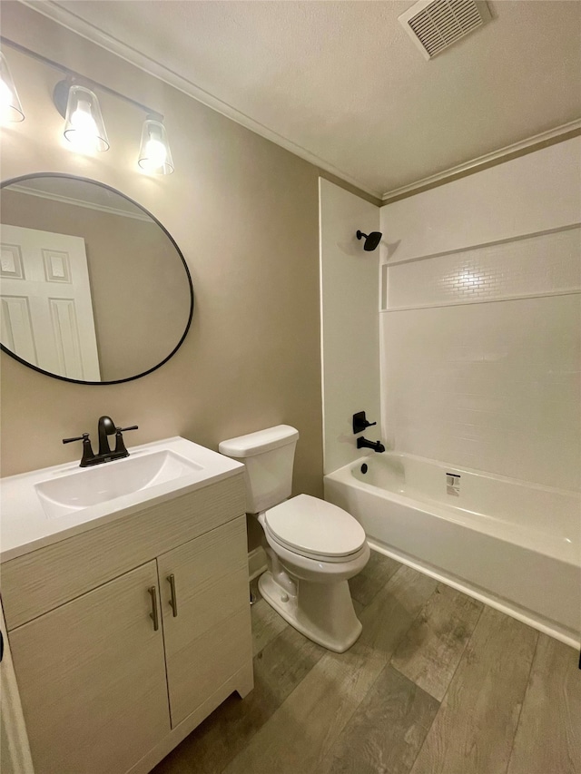 full bathroom with hardwood / wood-style floors, vanity, toilet, and shower / tub combination