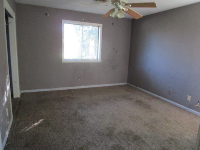 spare room with carpet flooring and ceiling fan