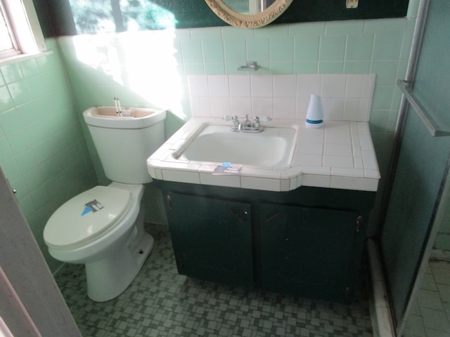 bathroom featuring decorative backsplash, toilet, tile walls, and sink